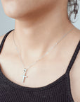 Dije cruz de esferas